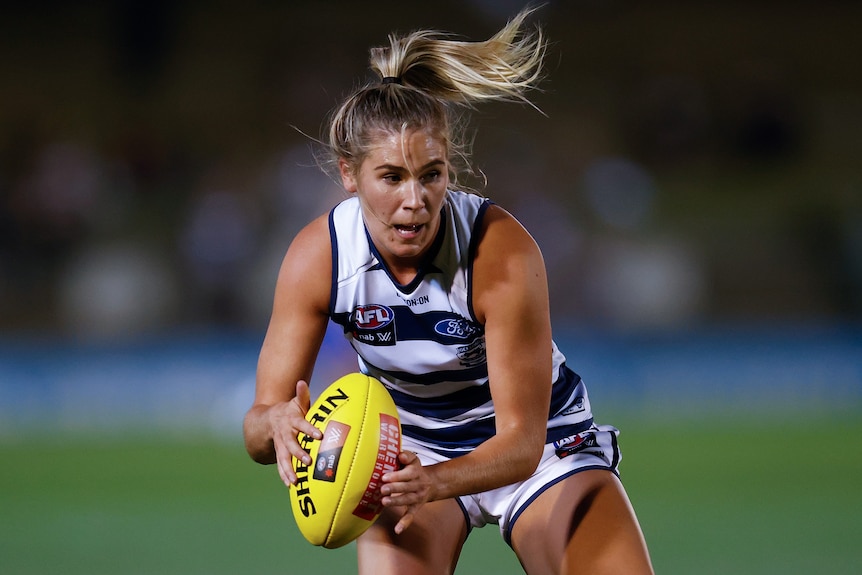 Rebecca Webster catches the ball during an AFLW match.
