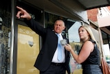 Rachael Brown interviewing Rod Iddles for the Trace podcast outside shops in High Street, Thornbury.