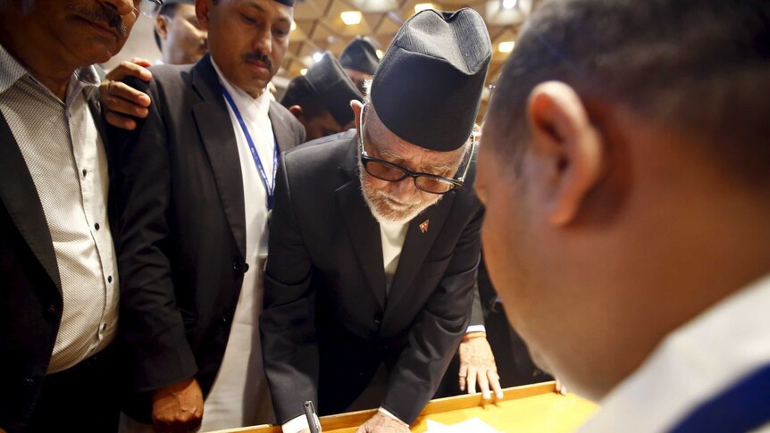 Nepalese prime minister Sushil Koirala signs on the copy of constitution