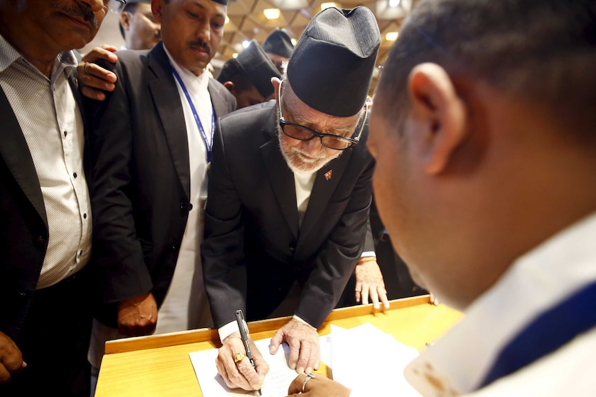 Nepalese prime minister Sushil Koirala signs on the copy of constitution