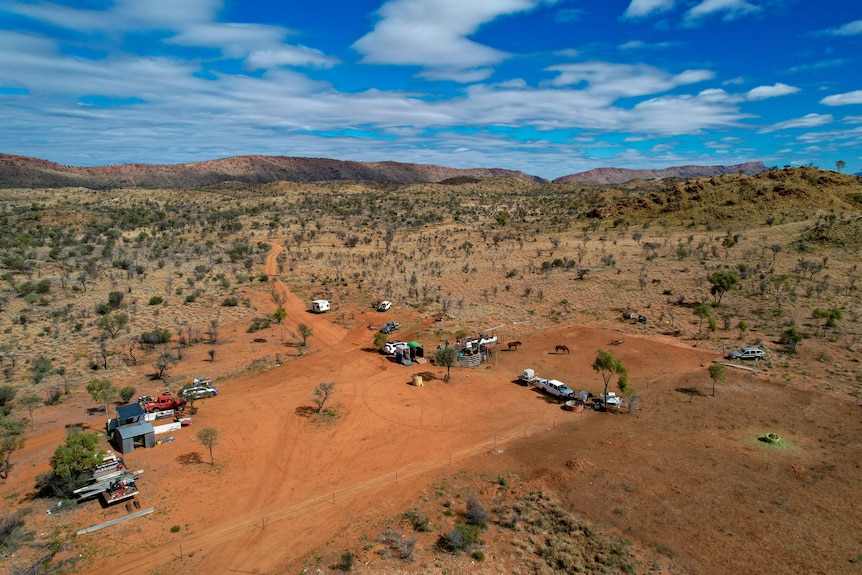 Aerial shot of a dusty red dirt paddock in central Australia. 