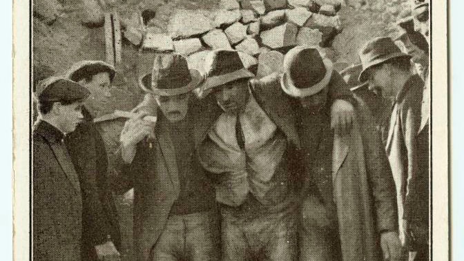 An old  photo shows the rescue of  a Mount Lyell miner in the 1912 disaster