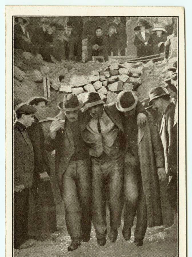 An old  photo shows the rescue of  a Mount Lyell miner in the 1912 disaster