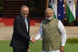 Anthony Albanese (left) and Narendra Modi shake hands for camera.