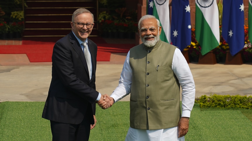 Anthony Albanese (left) and Narendra Modi shake hands for camera.