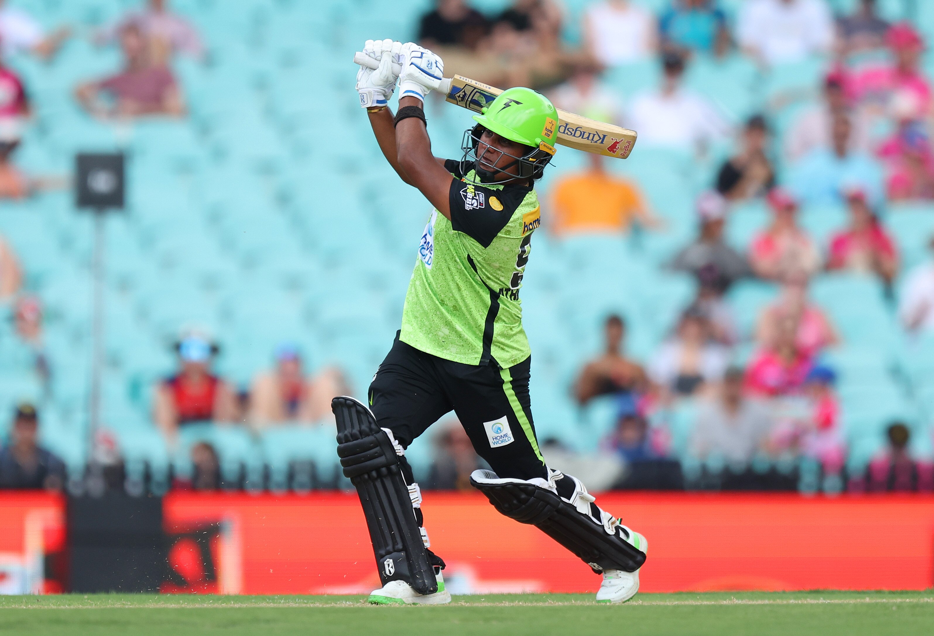 After making contact with the ball, Chamari watches it head down the ground as she raises her bat over her shoulder