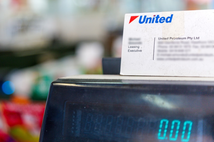 A United Petroleum business card sits on a cash register