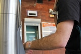 A man using his arm to swipe on public transport.
