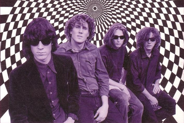 Purple-hued photo of The Early Hours band members against a psychedelic black and white checkered background.