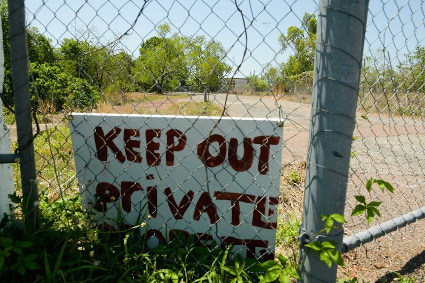 A sign reads 'keep out, private' behind a fence on a block in The Gardens.'
