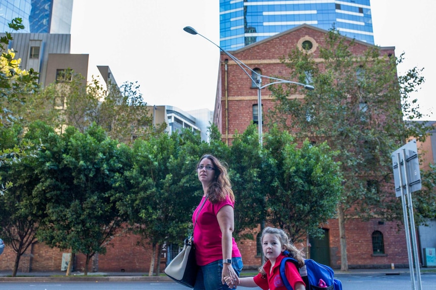 Chloe McMurtrie holding her mum's hand on the way to school.