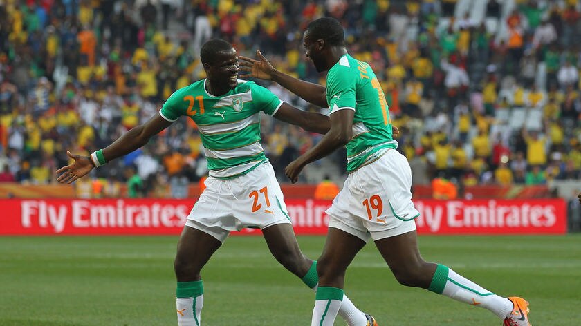 Comfortable win: Yaya Toure celebrates scoring the opening goal with team-mate Emmanuel Eboue.