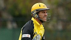 Justin Langer clutches his cracked rib