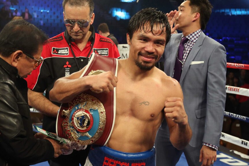 Manny Pacquiao celebrates after regaining the WBO welterweight title against Timothy Bradley