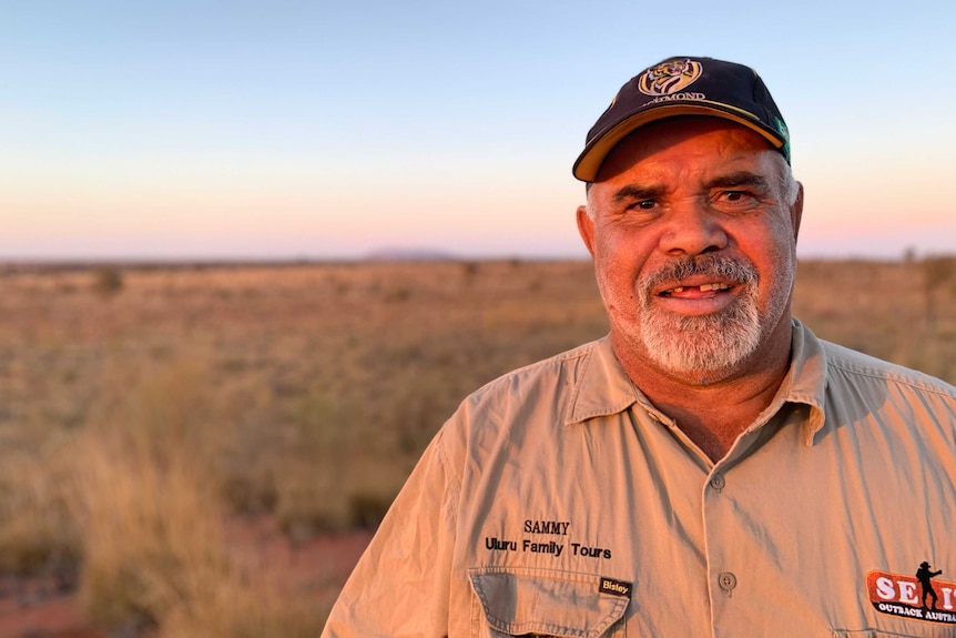 Sammy Wilson stands at his remote outstation near Uluru