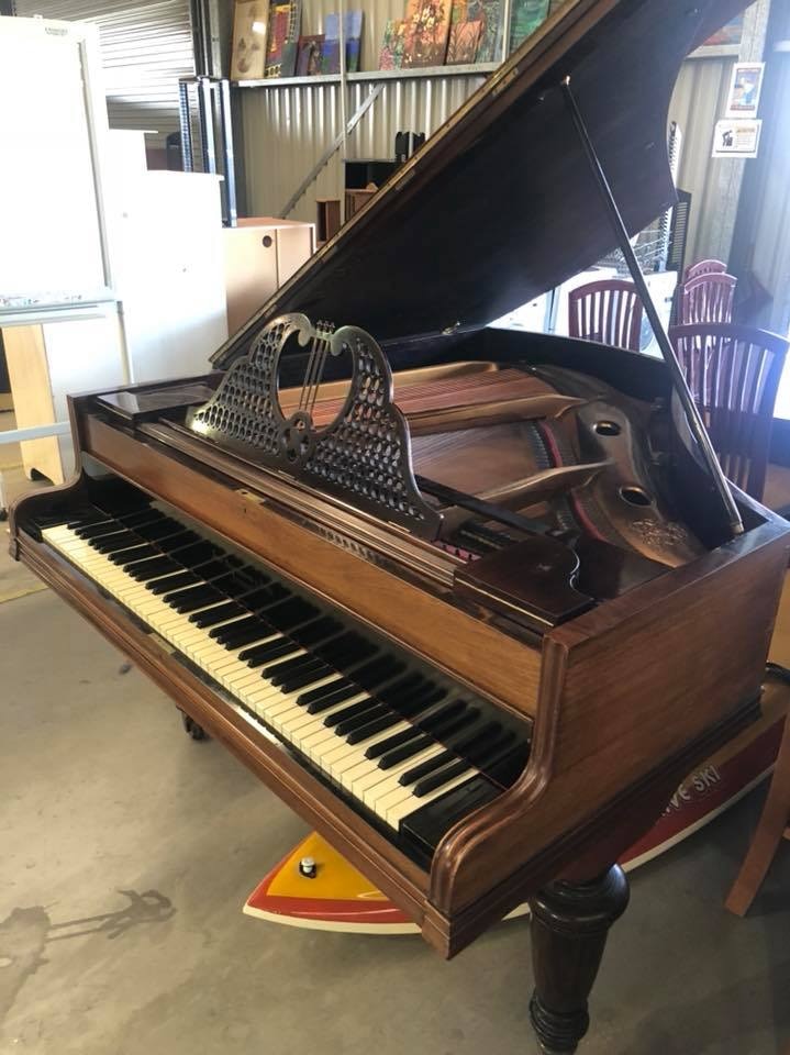 A grand piano at an op-shop.