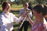 Julia Gillard and Emily Bolto admire a hand painted shovel in Kununurra
