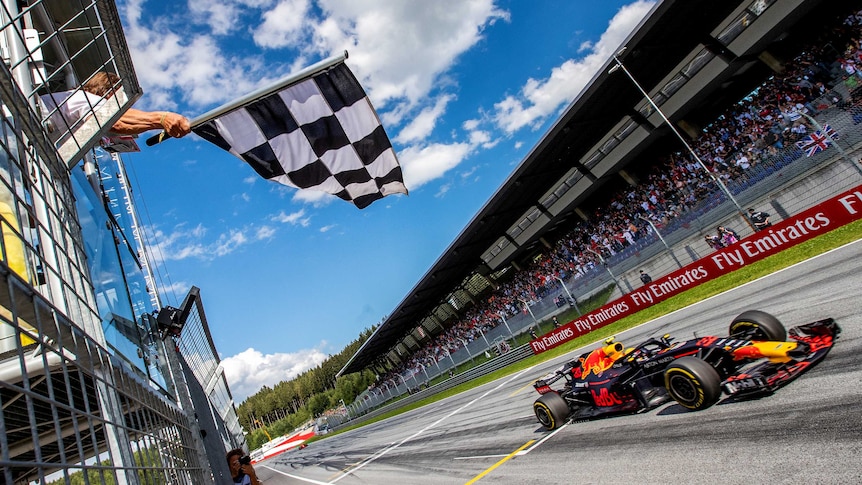 Red Bull's Max Verstappen crosses the finish line to take the chequered flag at the Austrian F1 GP.