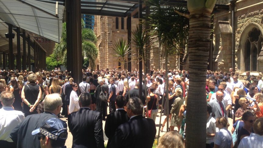 People congregate outside a church for Cole Miller's funeral.