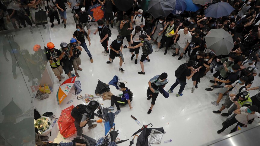 Protesters scuffle with policemen inside a shopping mall.