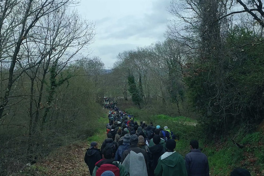 Refugees walking near Idomeni camp in Greece