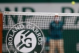 A picture of the French Open tournament logo attached to the net at Roland Garros.