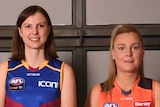 A number of footballers stand smiling in a group shot after round one of the AFLW Draft.