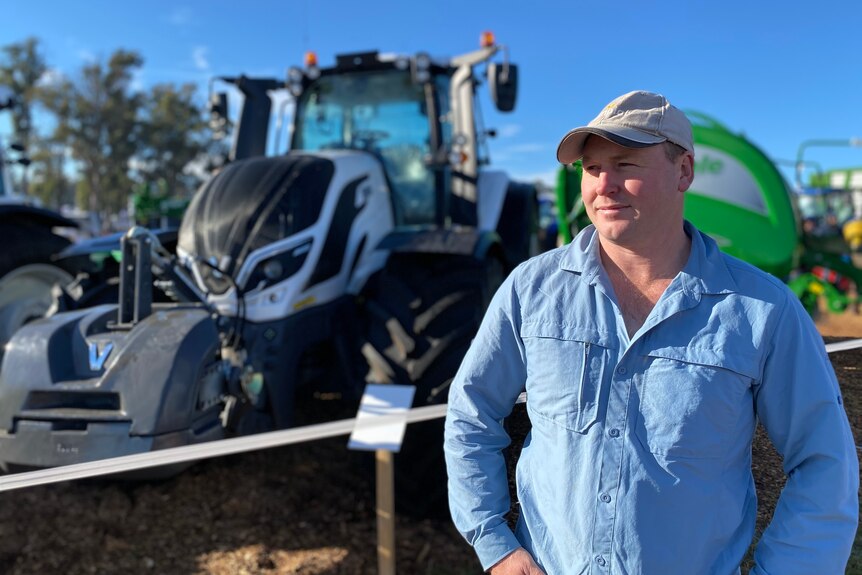 Sisters Creek farmer Michael Nichols standing in front of a large tractor.