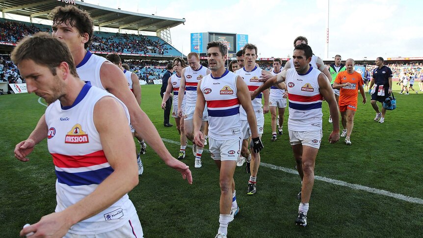 Bulldogs players walk off the ground at half-time against the Crows at Football Park.