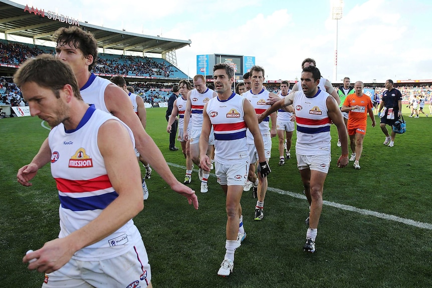 Bulldogs players walk off the ground at half-time against the Crows at Football Park.