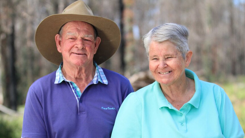Al Morris, in a hat and purple top, next to his wife Kath Morris, while both are smiling happily.