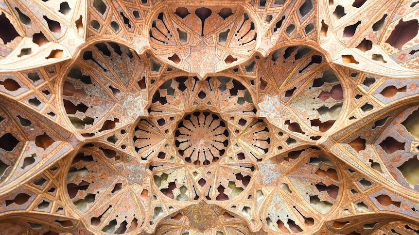 Elaborate ceiling with repeating patterns and shapes in the architecture