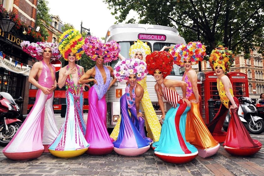 Priscilla drag queens pose in a London street