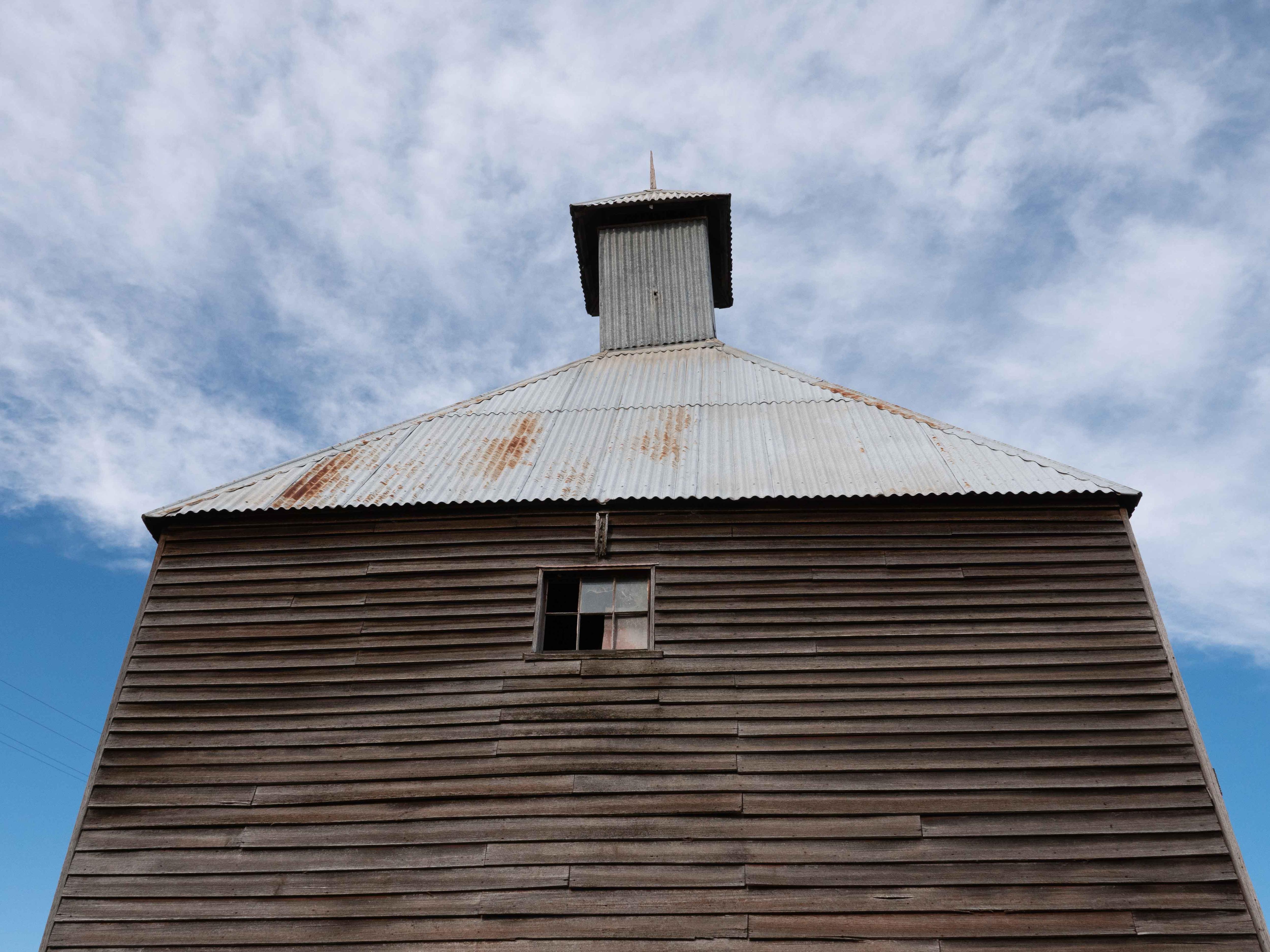 An old wooden building, with a spire at the top