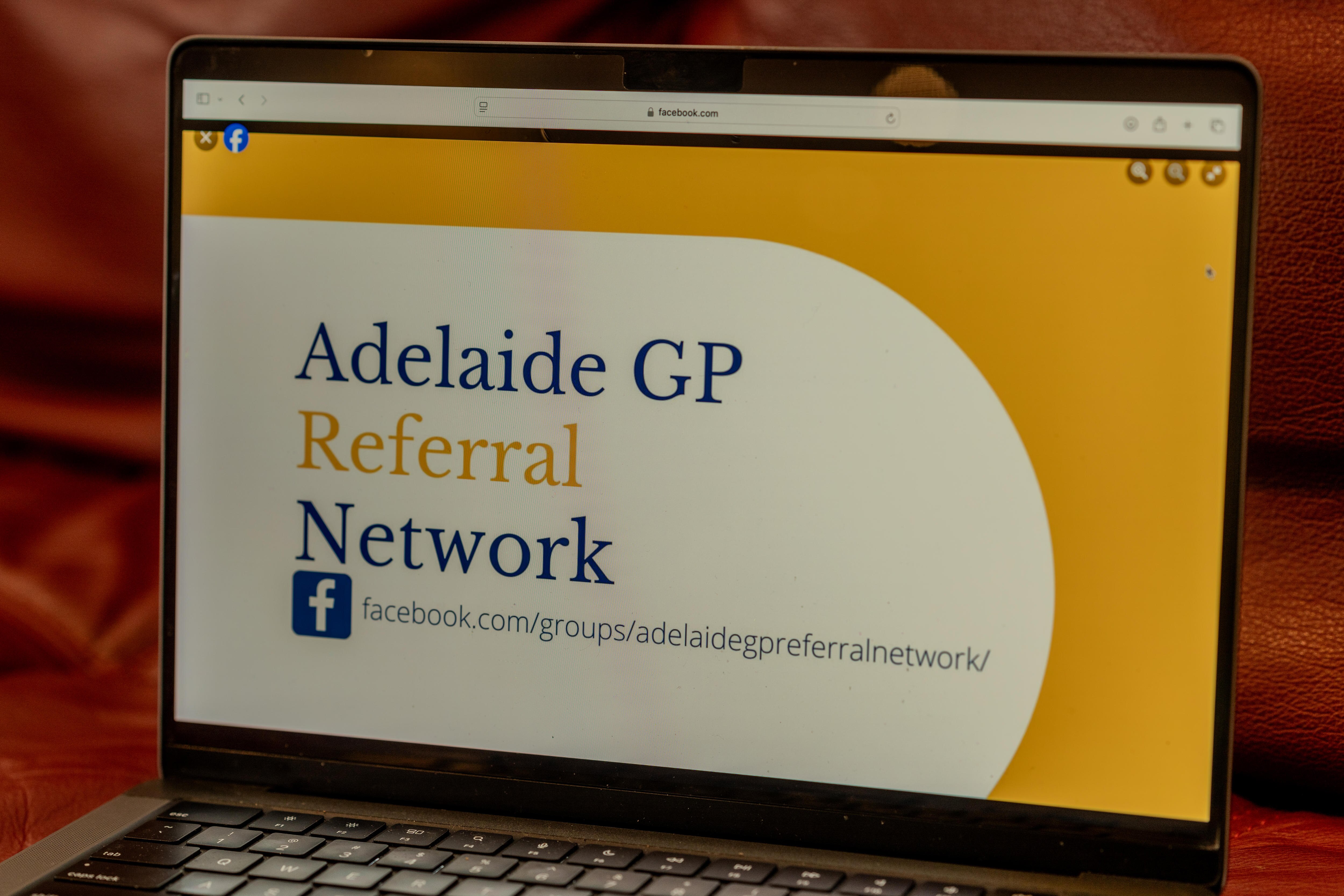 A laptop screen shows the Adelaide GP Referral Network Facebook page