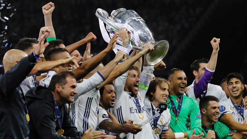 Real Madrid holds aloft the Champions League trophy after its defeat of Juventus.