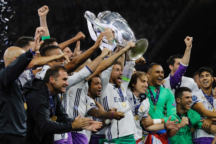 Real Madrid holds aloft the Champions League trophy after its defeat of Juventus.