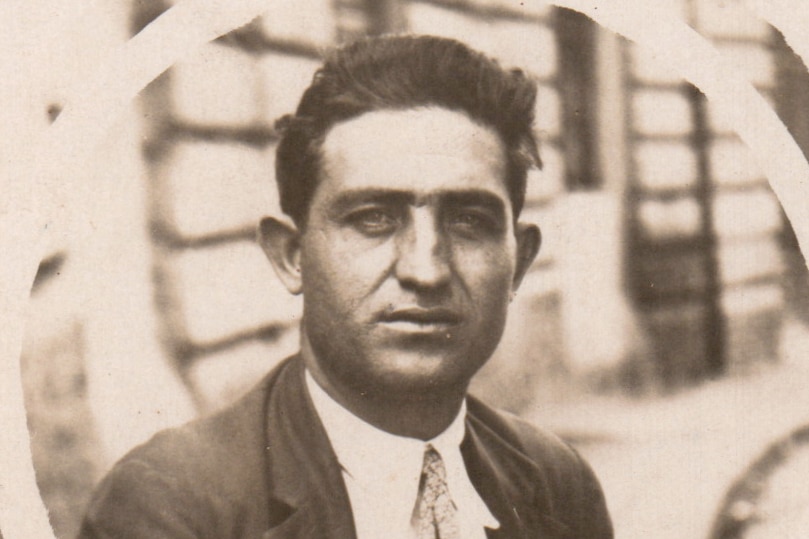 A sepia photo of Domenic Scarcella looking straight at the camera