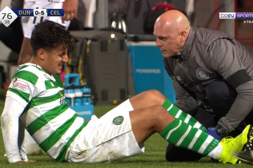 Daniel Arzani is treated on the pitch.