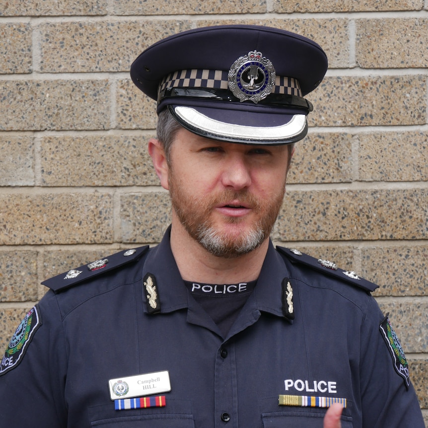 A police officer speaking at a press conference. 