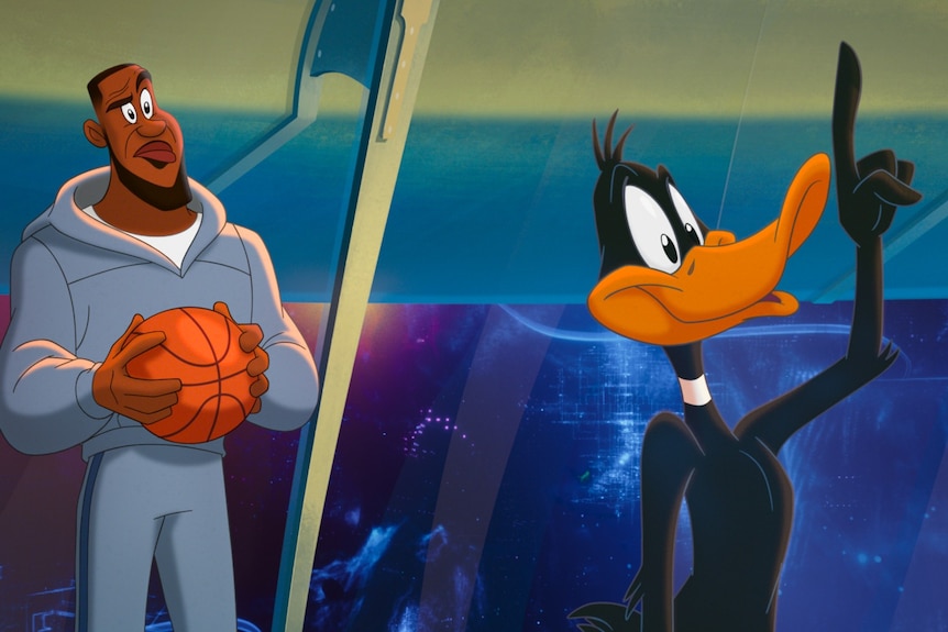 A cartoon LeBron James holding a basketball looks confused, looking at Daffy Duck who has one arm raised in the air 