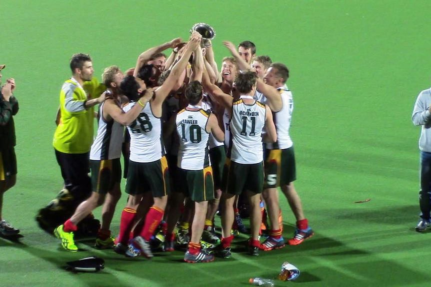 Tasmania's hockey team the Tassie Tigers celebrate their 2014 AHL tournament win.