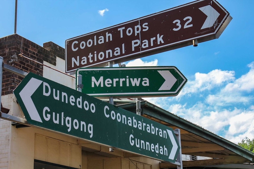Road signs in town point to Coolah Tops National Park and directions to Merriwa, Dunedoo and Coonabarabran