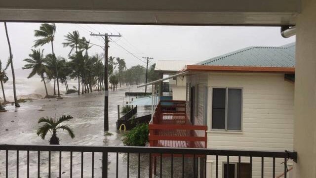 A beachside street is flooded at Seaforth in Mackay.