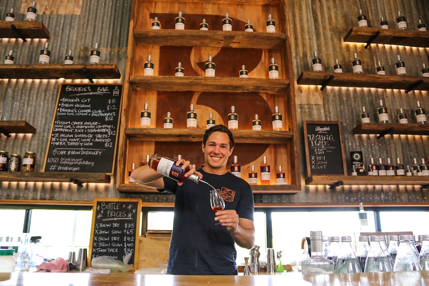 Cape Byron Distillery CEO Eddie Brook pours a glass of Davidson Plum Slow Gin.