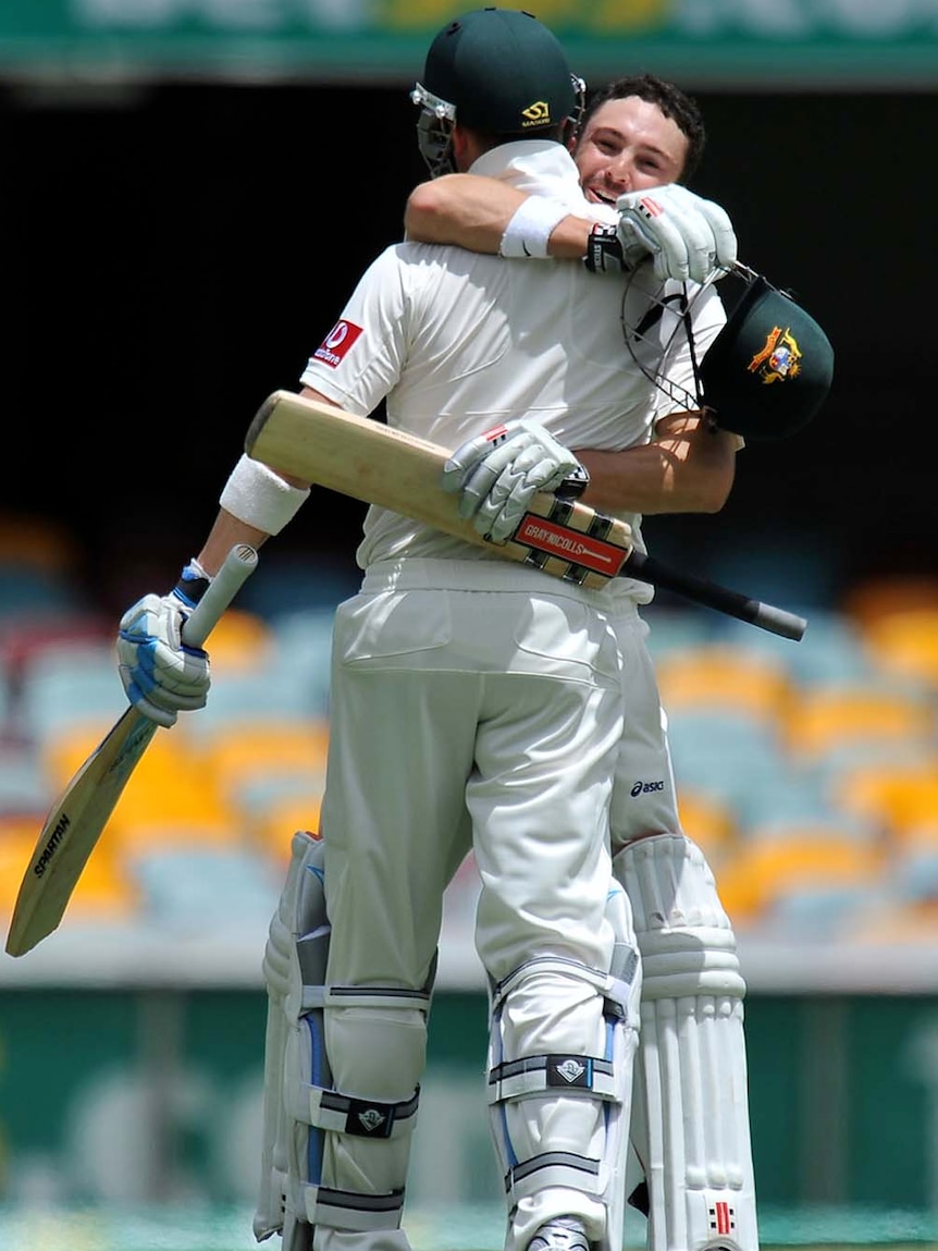 Ed Cowan embraces his state school-educated captain Michael Clarke.