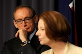 Former NSW premier Bob Carr listens at a press conference with Prime Minister Julia Gillard in Canberra, Friday, March 2, 2012.