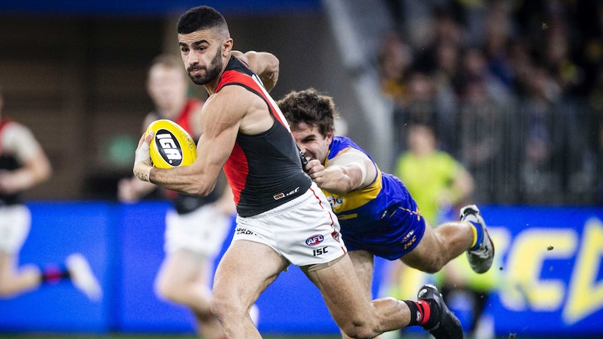 Adam Saad running with the ball away from the Eagles defence.