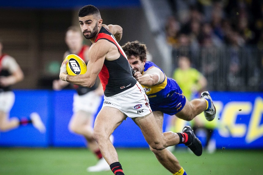 Adam Saad running with the ball away from the Eagles defence.