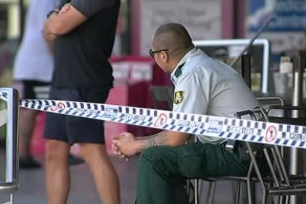 A man sitting down after being the target of a robbery